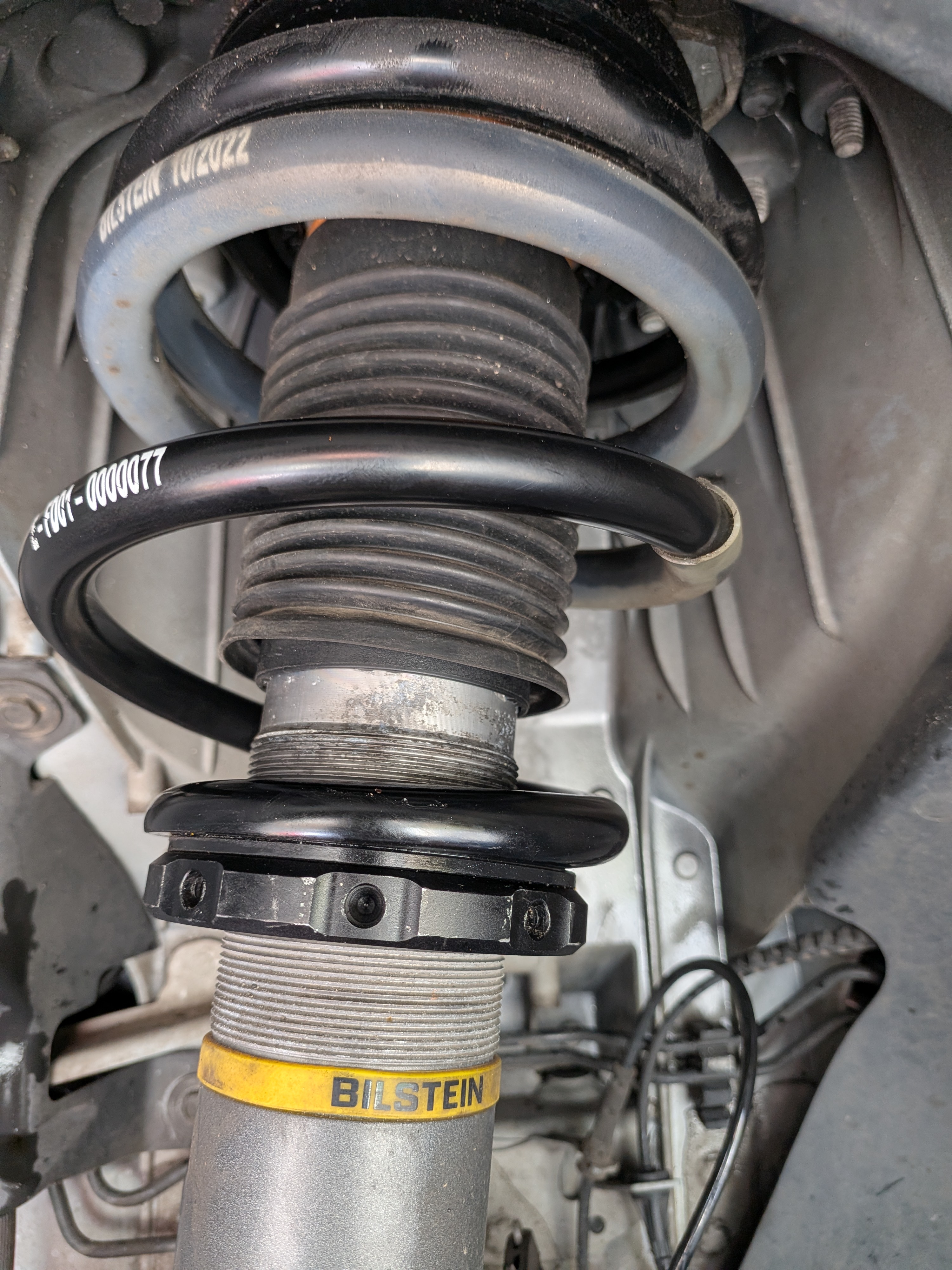 Bilstein EVO S front strut installed on DV-001 — perch collar and spring seat in wheel well